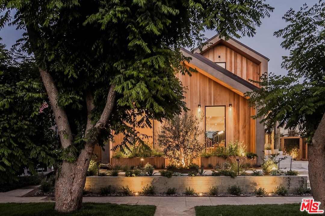 Warmly lit Los Angeles home and garden at dusk